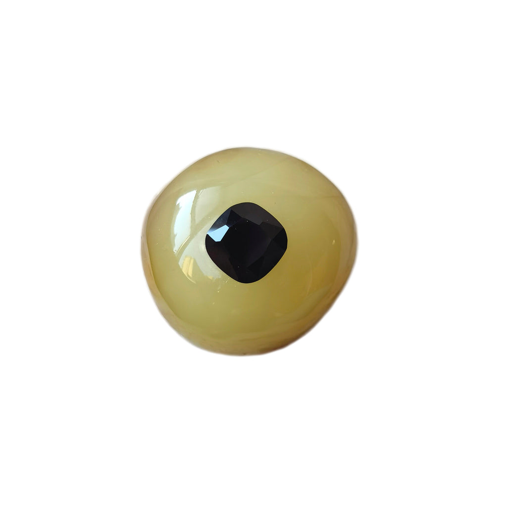 I’m Watching You · Amber & Cushion Black Spinel Brooch — Single artificial eye on a white background
