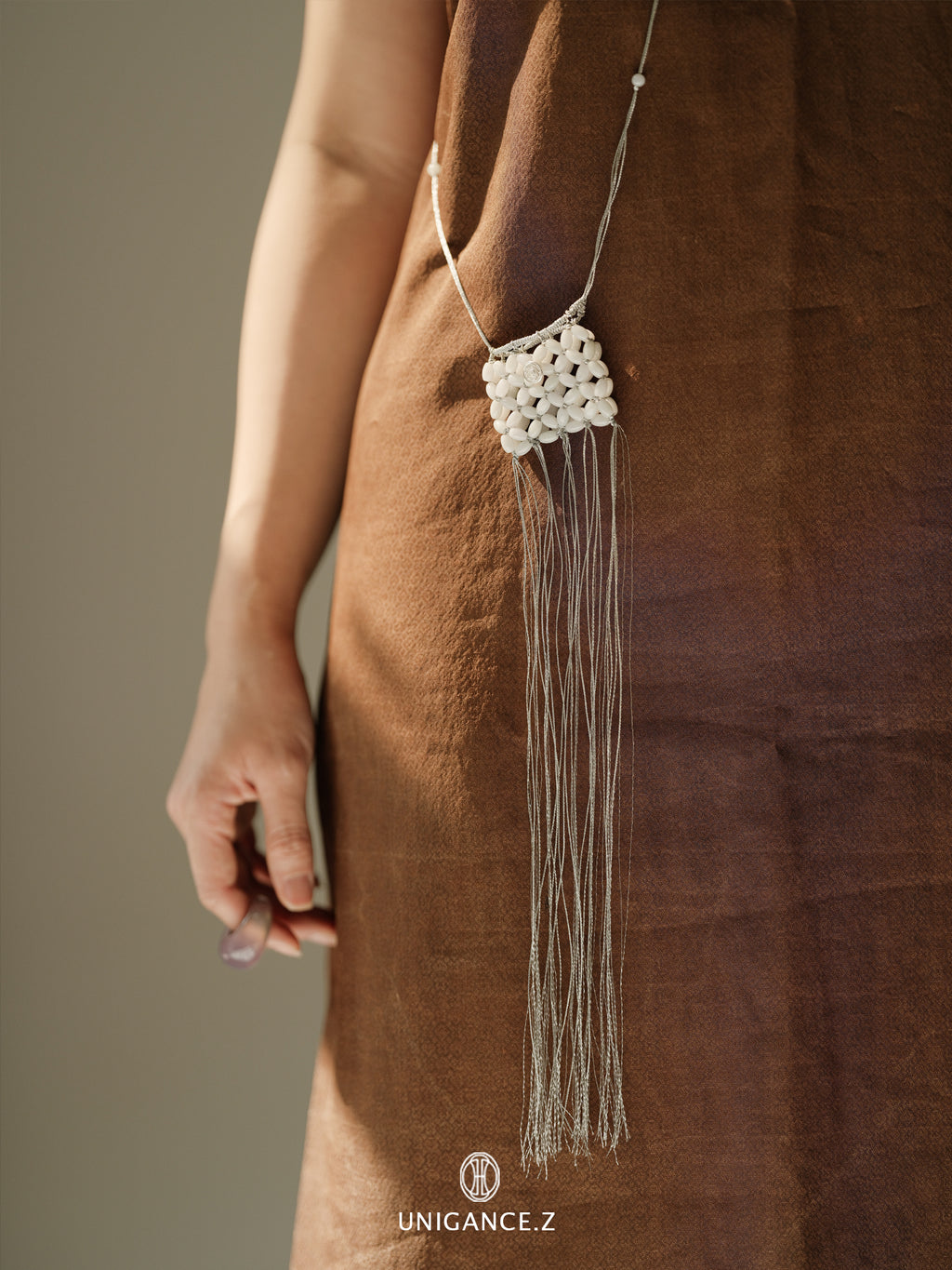 Jade Beaded Pouch — Necklace with tassels worn by a person in a brown dress, with 'UNIGANCE.Z' branding.