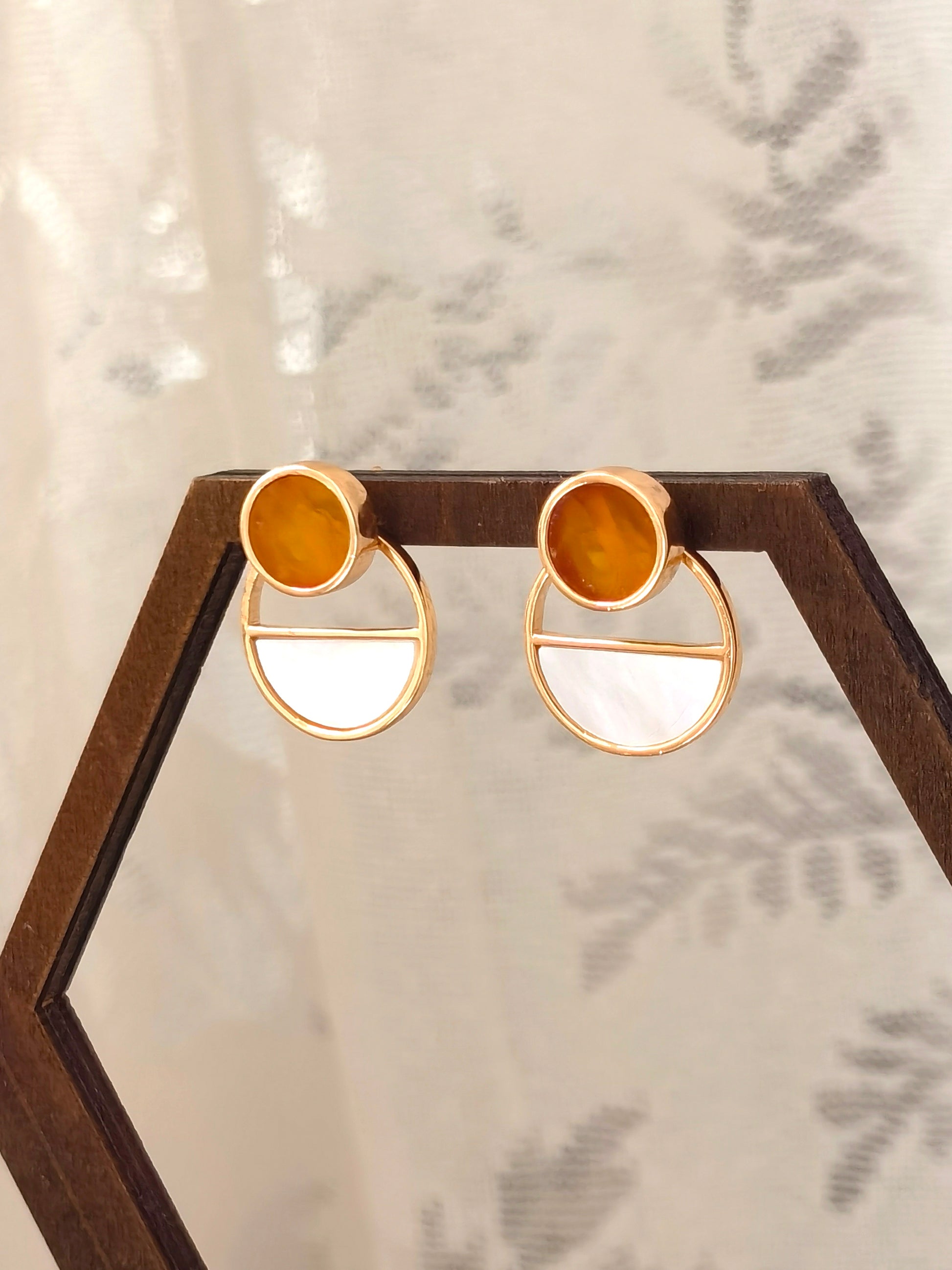 Meicily convertible earrings worn as sculptural statement drops or simple amber studs for everyday elegance.