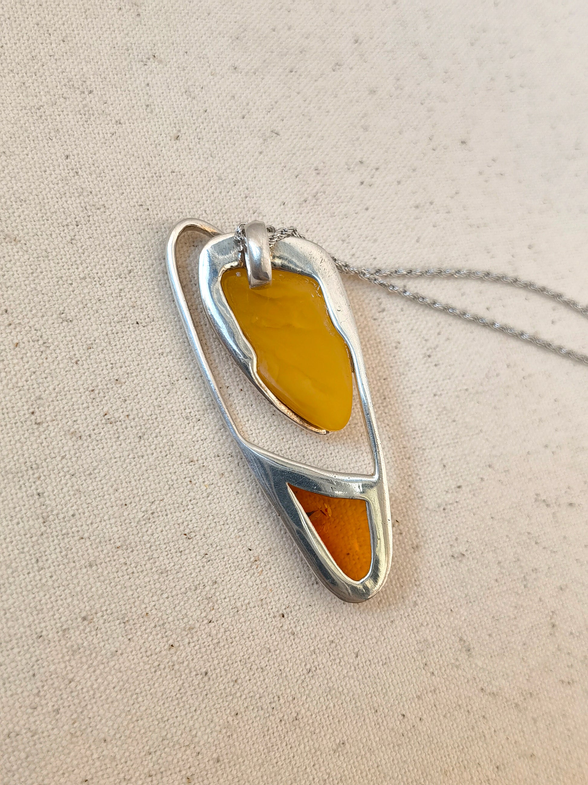 Meicily unique sculptural amber necklace with golden and floral amber joined in seamless silver.”