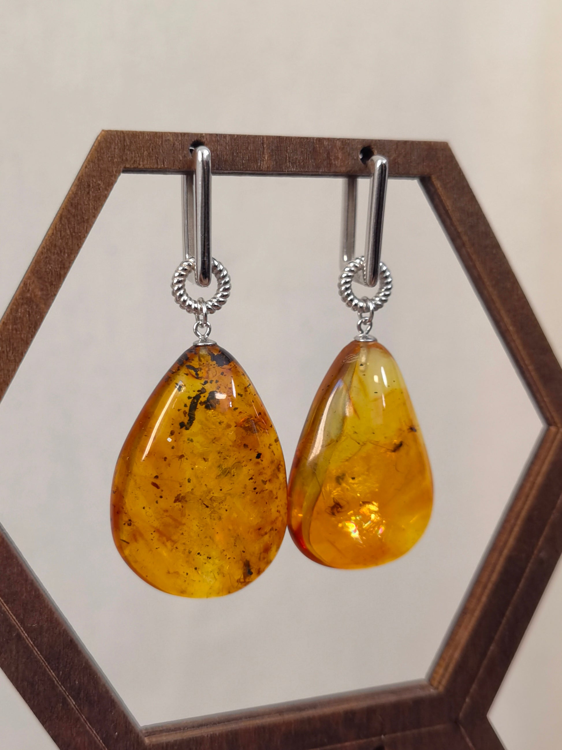 Meicily convertible amber earrings worn as statement dangles or minimalist hoops, celebrating time and nature