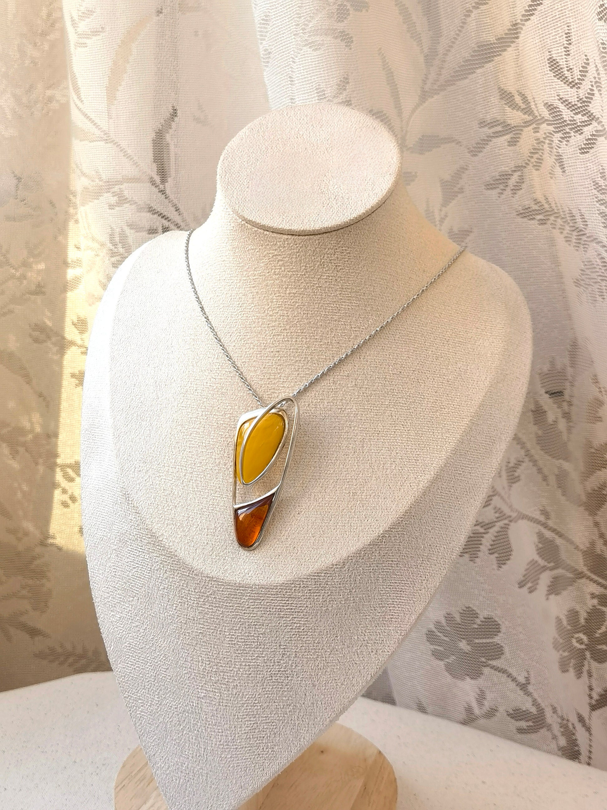 Meicily handcrafted amber necklace showcasing natural inclusions and organic contrast between two amber shades.”