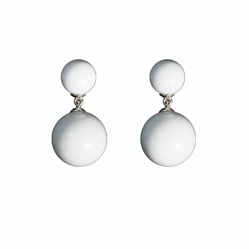 Pair of earrings with two white spherical beads on a white background