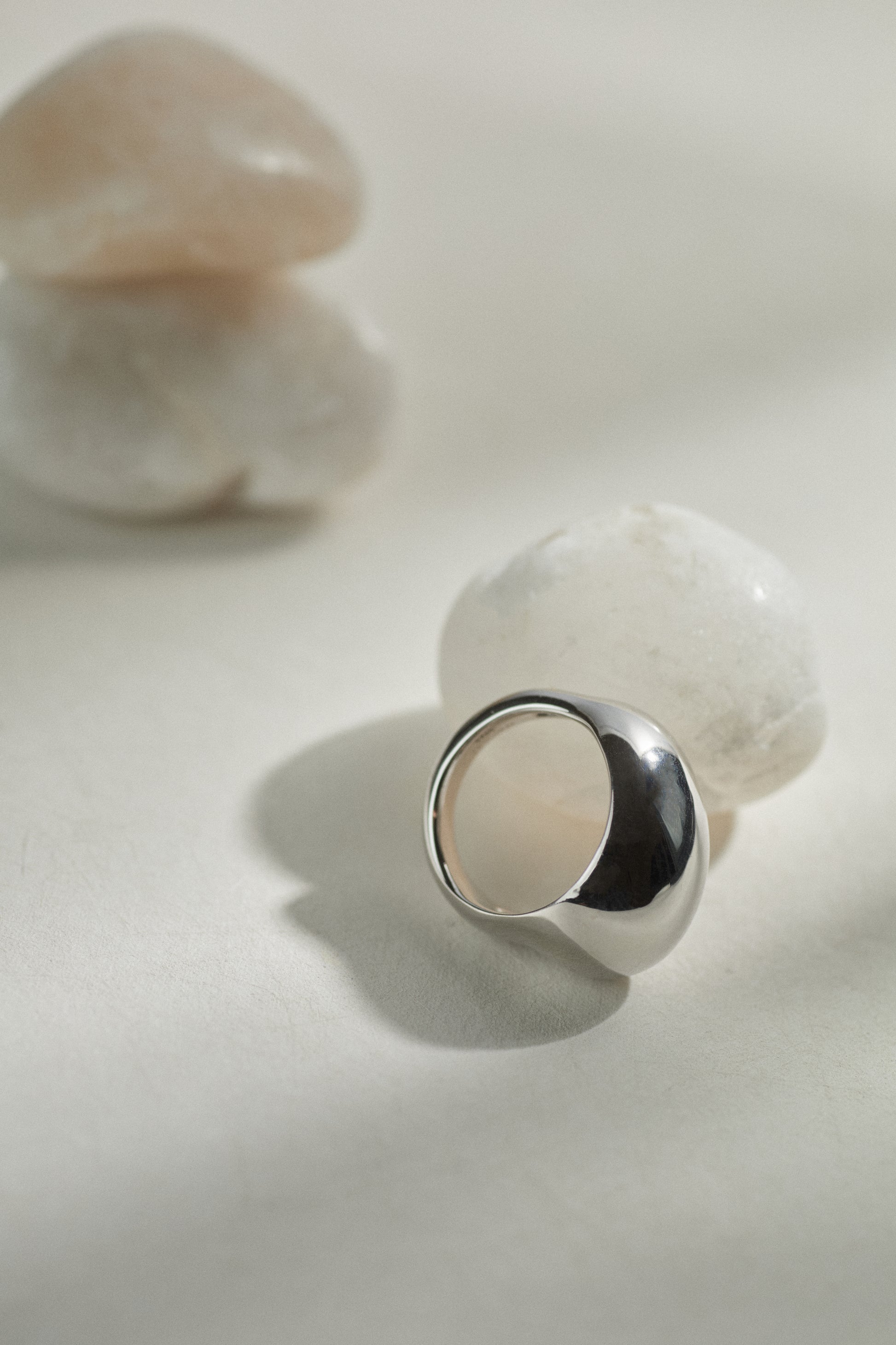 Silver ring with a crescent moon design on a light background