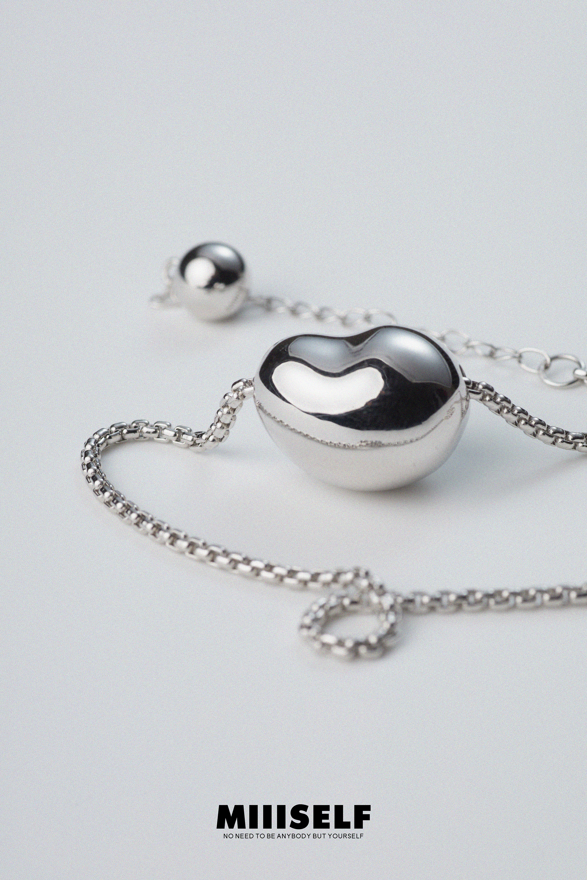 MIIISELF modern heart pendant necklace featuring smooth rounded form and subtle contemporary curves.”