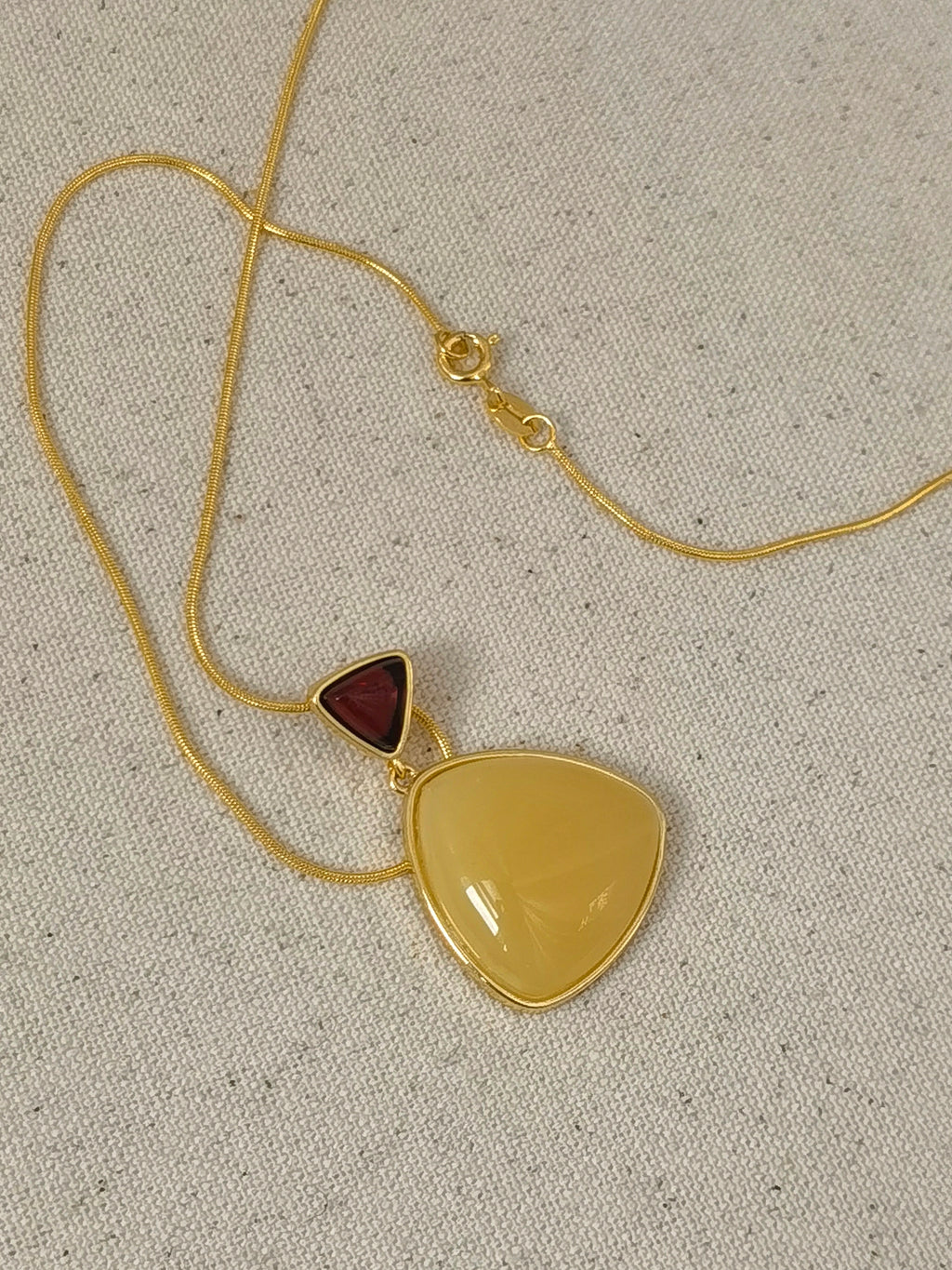 Natural Blood Amber & Beeswax Triangle Necklace — Meicily handcrafted amber necklace highlighting natural glow, clarity, and
