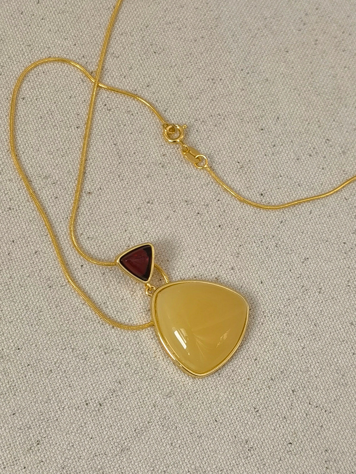 Natural Blood Amber & Beeswax Triangle Necklace — Meicily handcrafted amber necklace highlighting natural glow, clarity, and