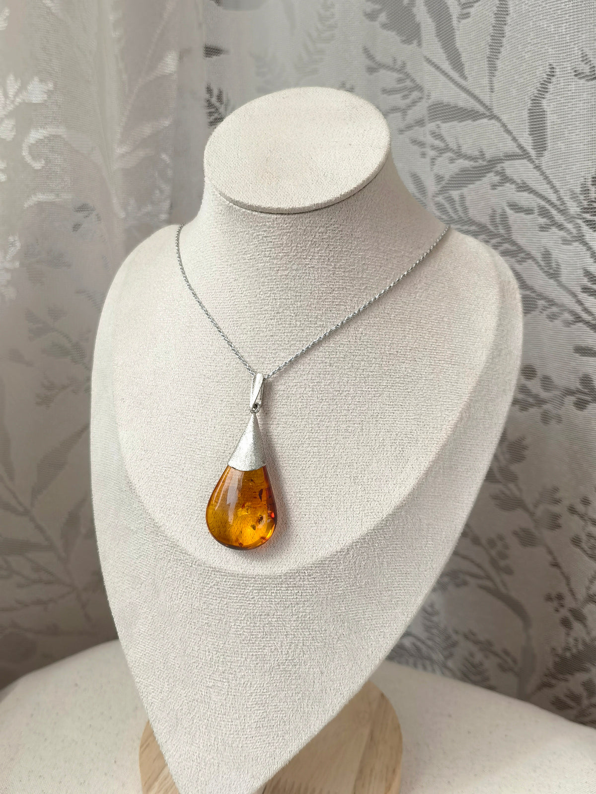 Meicily Natural Floral Amber & Matte Silver Necklace featuring handcrafted pendant with subtle plant inclusions