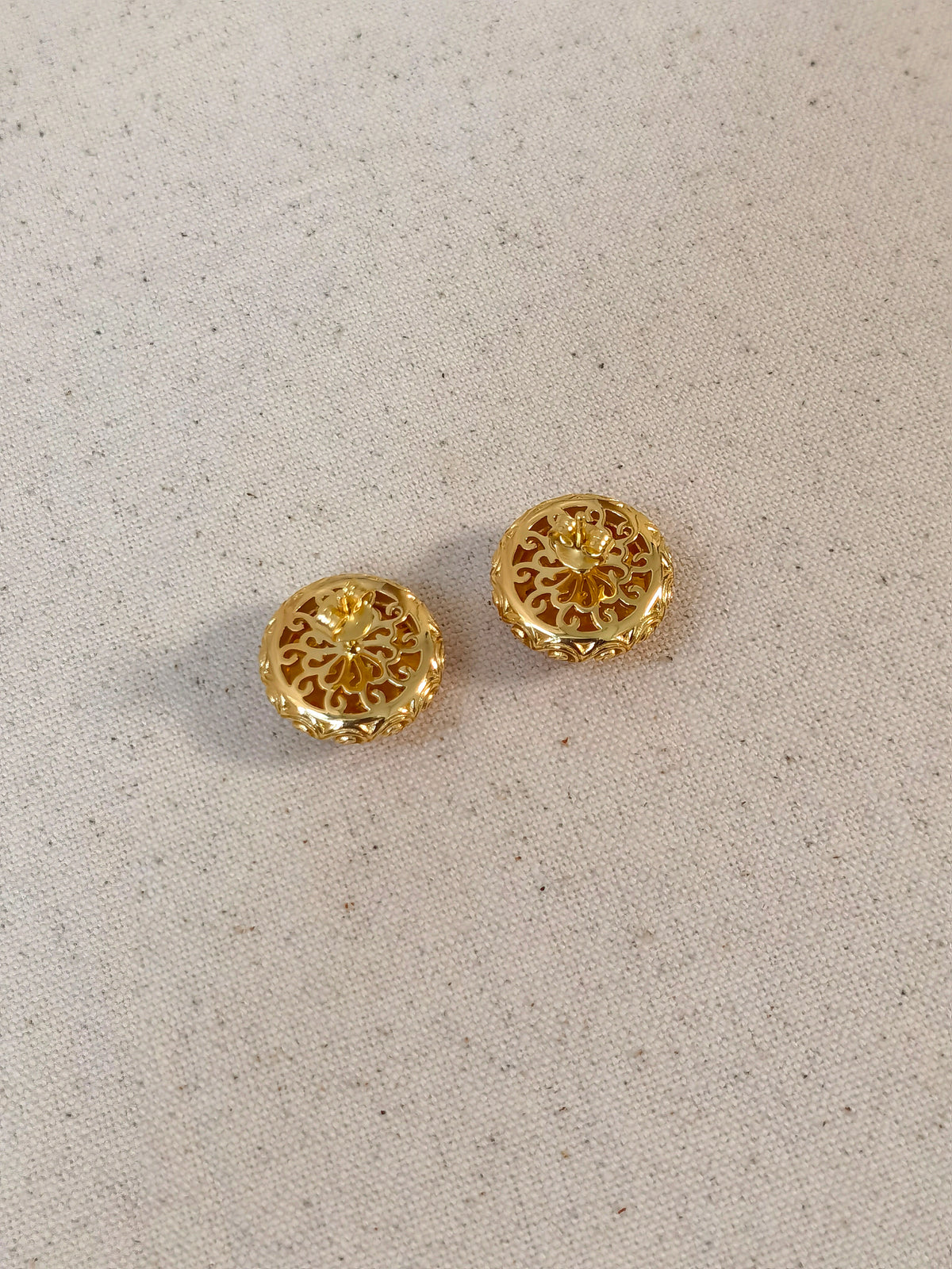 Natural Floral Amber Cabochon Earrings — Pair of gold earrings on a light gray background