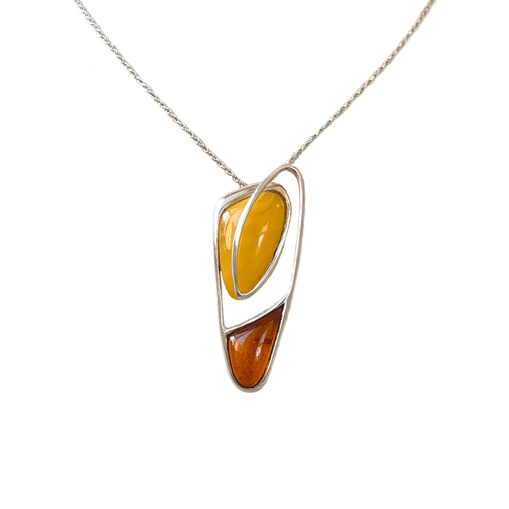 Meicily Natural Floral Amber Silver Necklace featuring golden beeswax and floral amber in a sculptural silver frame.