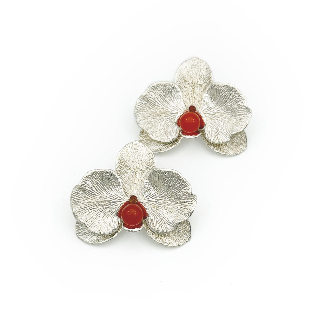 Phalaenopsis Orchid Convertible Earrings — Silver flower-shaped earrings with red centers on a white background