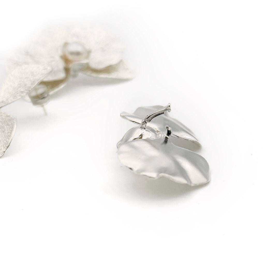Phalaenopsis Orchid Convertible Earrings — Silver ring with a heart-shaped design on a white background