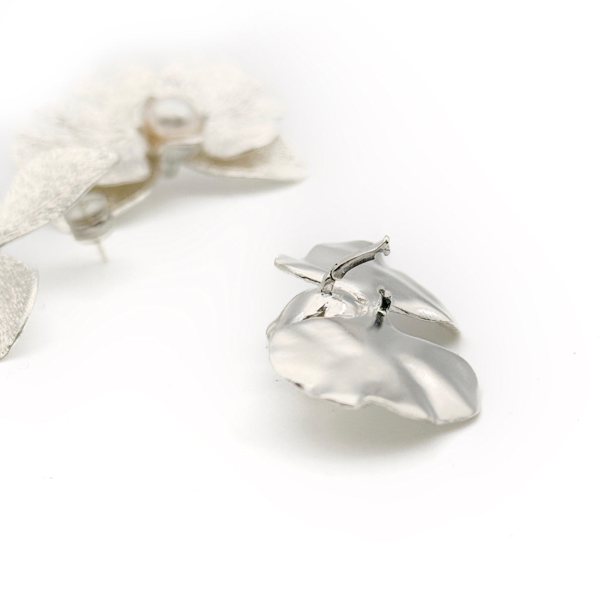 Phalaenopsis Orchid Convertible Earrings — Silver ring with a heart-shaped design on a white background