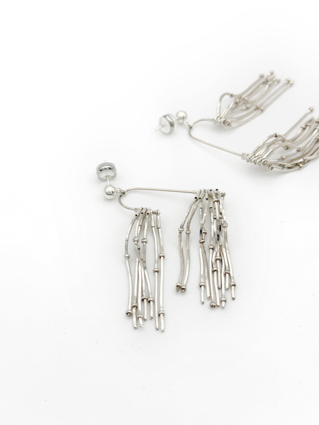 Pine Needle Drop Earrings — Silver fringe earrings on a white background