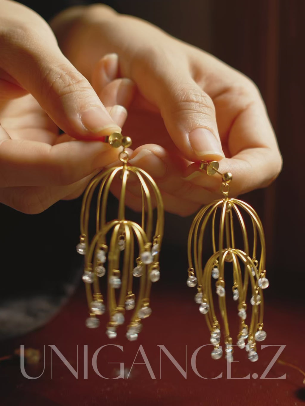 Handcrafted drooping begonia drop earrings in sterling silver, featuring cascading layered blossoms and light-catching stones, inspired by classical Chinese garden imagery, designed to frame the face with soft elegance, rhythm, and refined floral beauty.