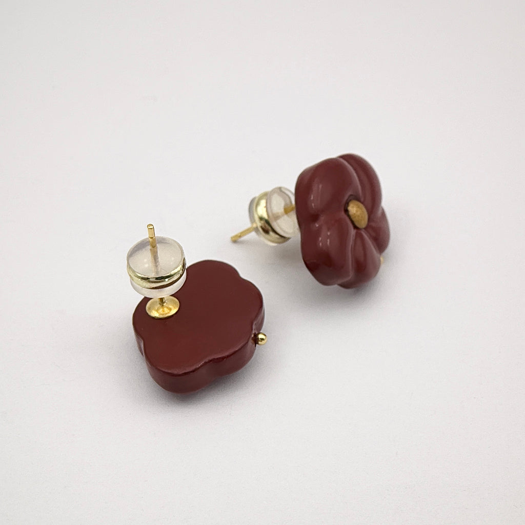 Red Peach Blossom Lacquer Quasi-Maki-e Earrings — Pair of brown earrings with gold accents on a light gray background