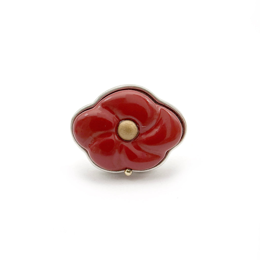 Red Peach Lacquer Quasi-Maki-e Blossom Ring — Red flower-shaped object with a gold center on a white background