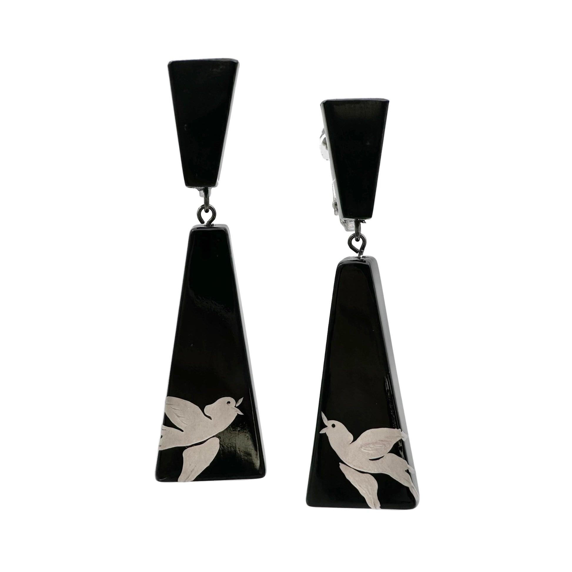 Black earrings with white bird designs on a white background