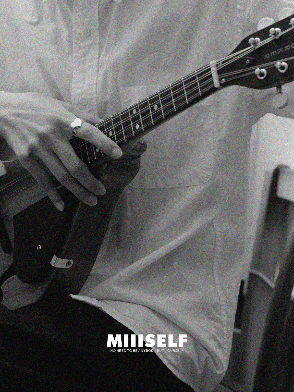 Silver Heart Signet Ring — Black and white photo of a person playing an electric guitar with 'MIIISELF' branding.