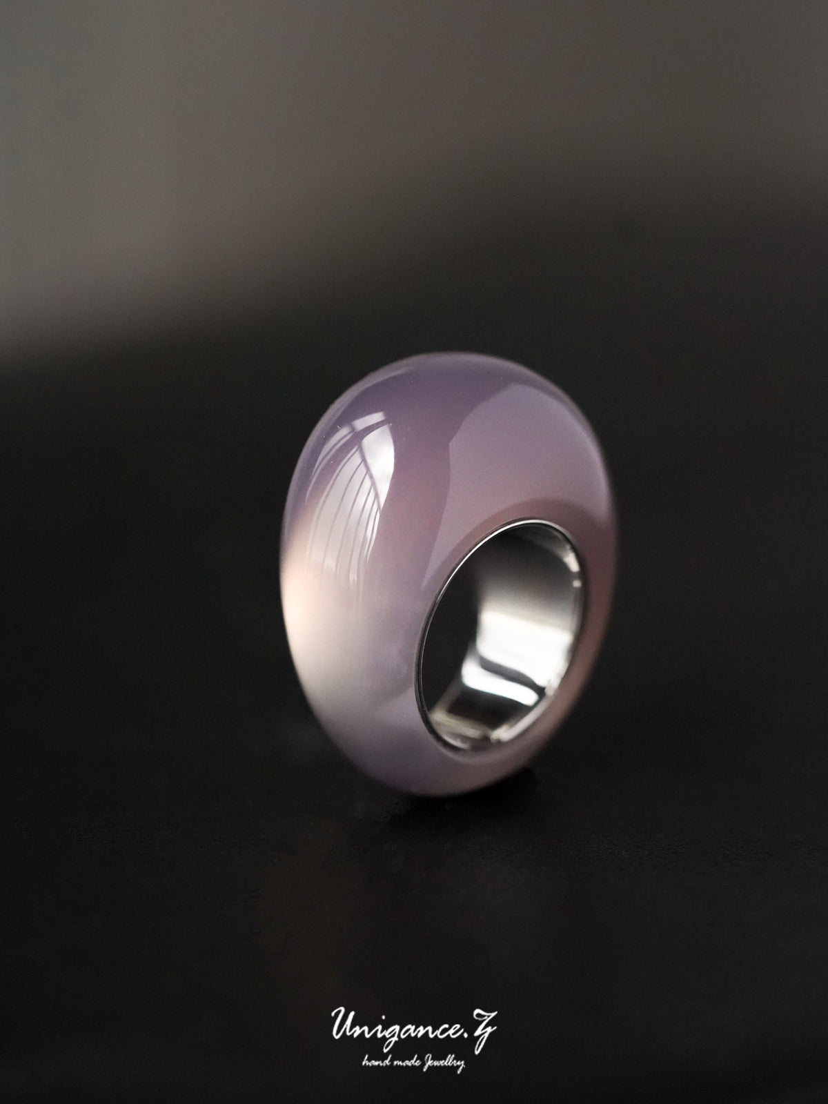 Smoky Purple Jade Band Ring — Silver ring with a purple gemstone on a dark background