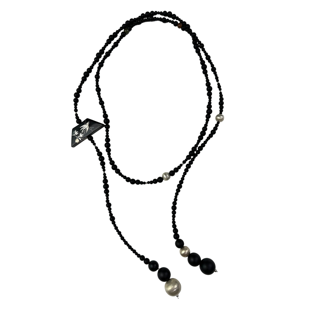 Snow Sparrow Lacquer Quasi-Maki-e Long Lariat Necklace — Black beaded necklace with silver accents on a light gray background