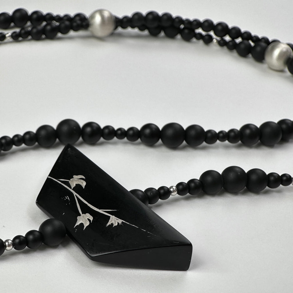 Snow Sparrow Lacquer Quasi-Maki-e Long Lariat Necklace — Black beaded necklace with a triangular pendant on a white