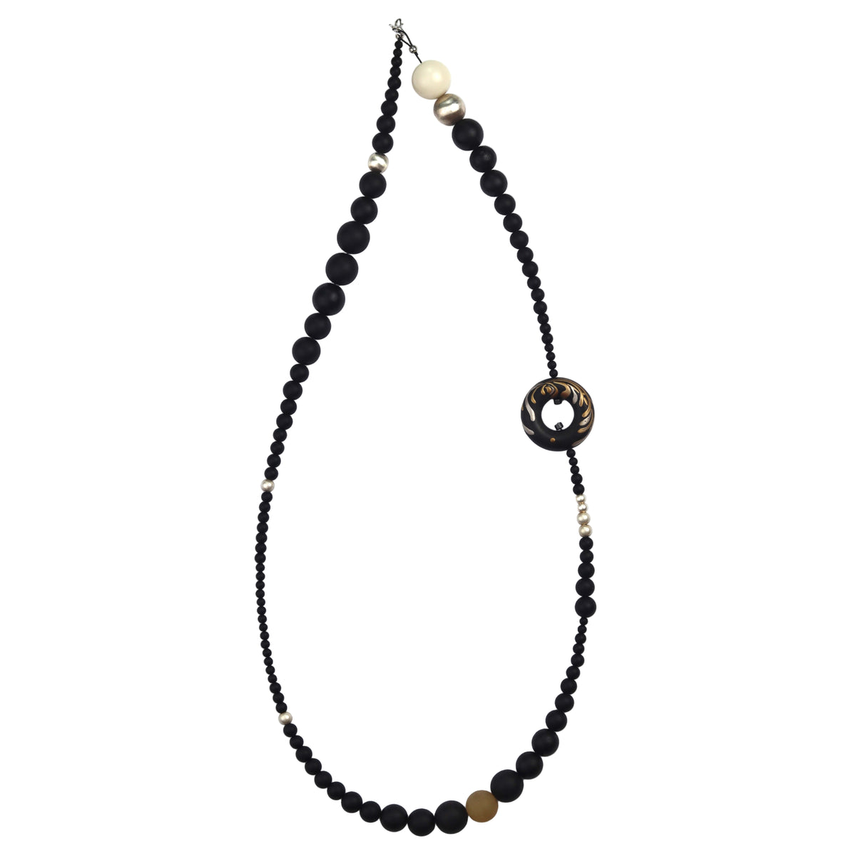 Soft Chrysanthemum Ebony Bodhi Lacquer Quasi-Maki-e Necklace — Necklace with black beads and a decorative clasp on a white