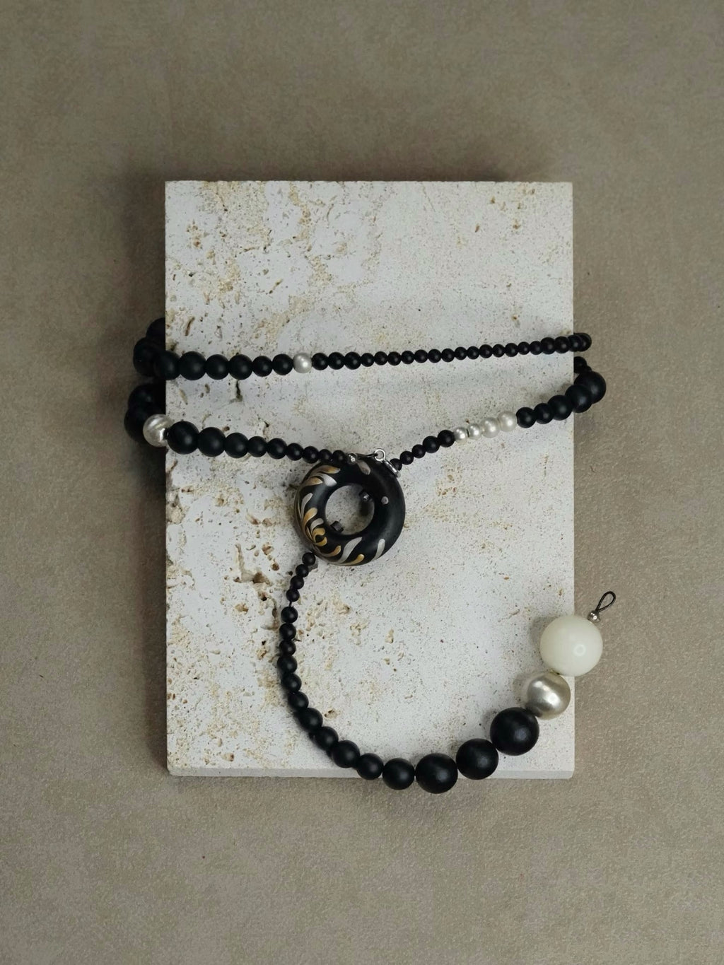 Soft Chrysanthemum Ebony Bodhi Lacquer Quasi-Maki-e Necklace — Black beaded necklace with a large central bead and smaller