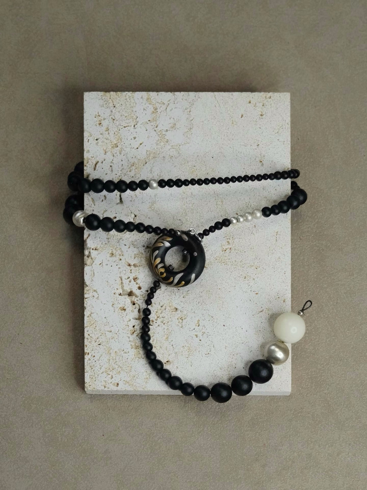 Soft Chrysanthemum Ebony Bodhi Lacquer Quasi-Maki-e Necklace — Black beaded necklace with a large central bead and smaller