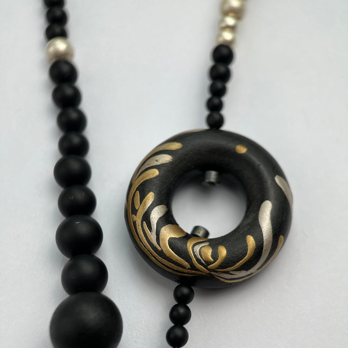 Soft Chrysanthemum Ebony Bodhi Lacquer Quasi-Maki-e Necklace — Necklace with black beads and a decorative black and gold