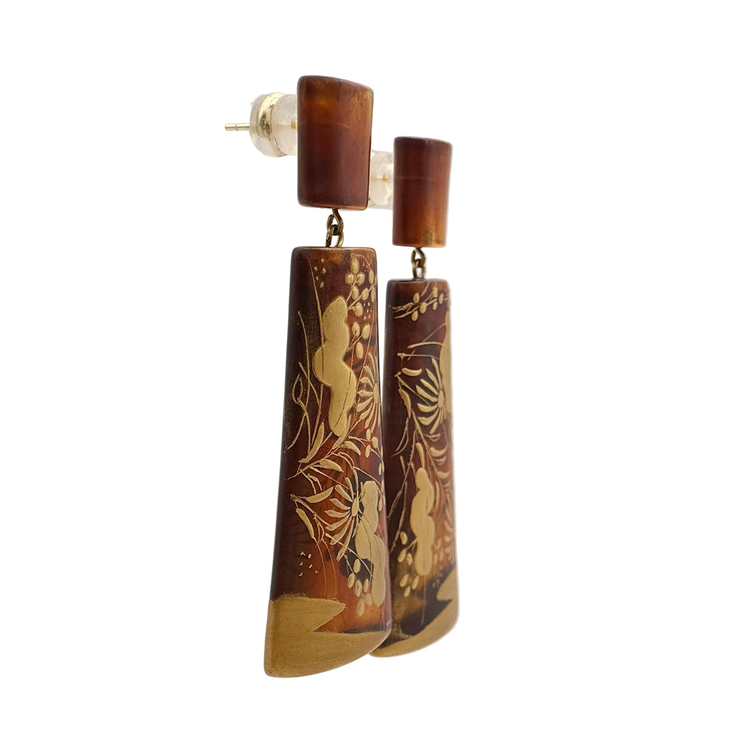 Sunset Watergrass Lacquer Quasi-Maki-e Earrings — Pair of wooden earrings with intricate carvings on a white background