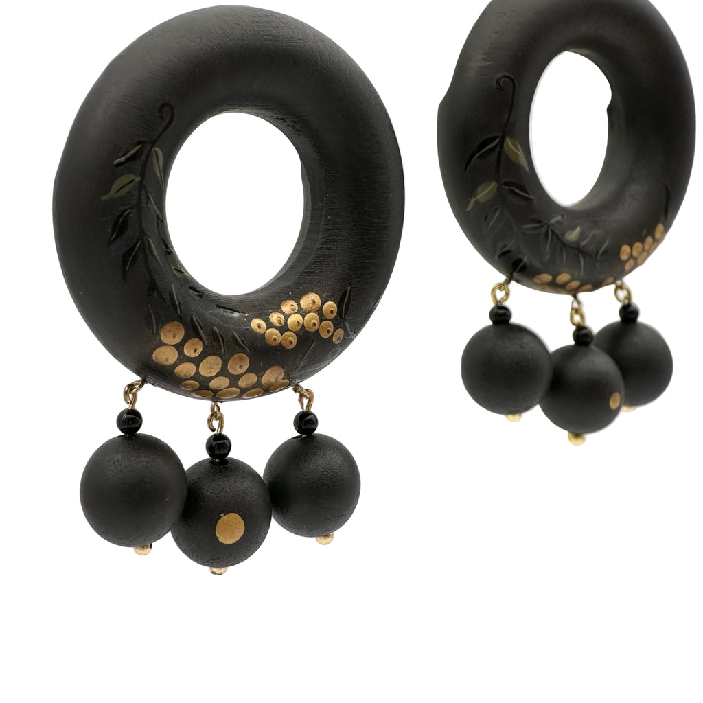 Tenjiku Black Lacquer Drop Earrings — Black hoop earrings with gold accents and black beads on a white background