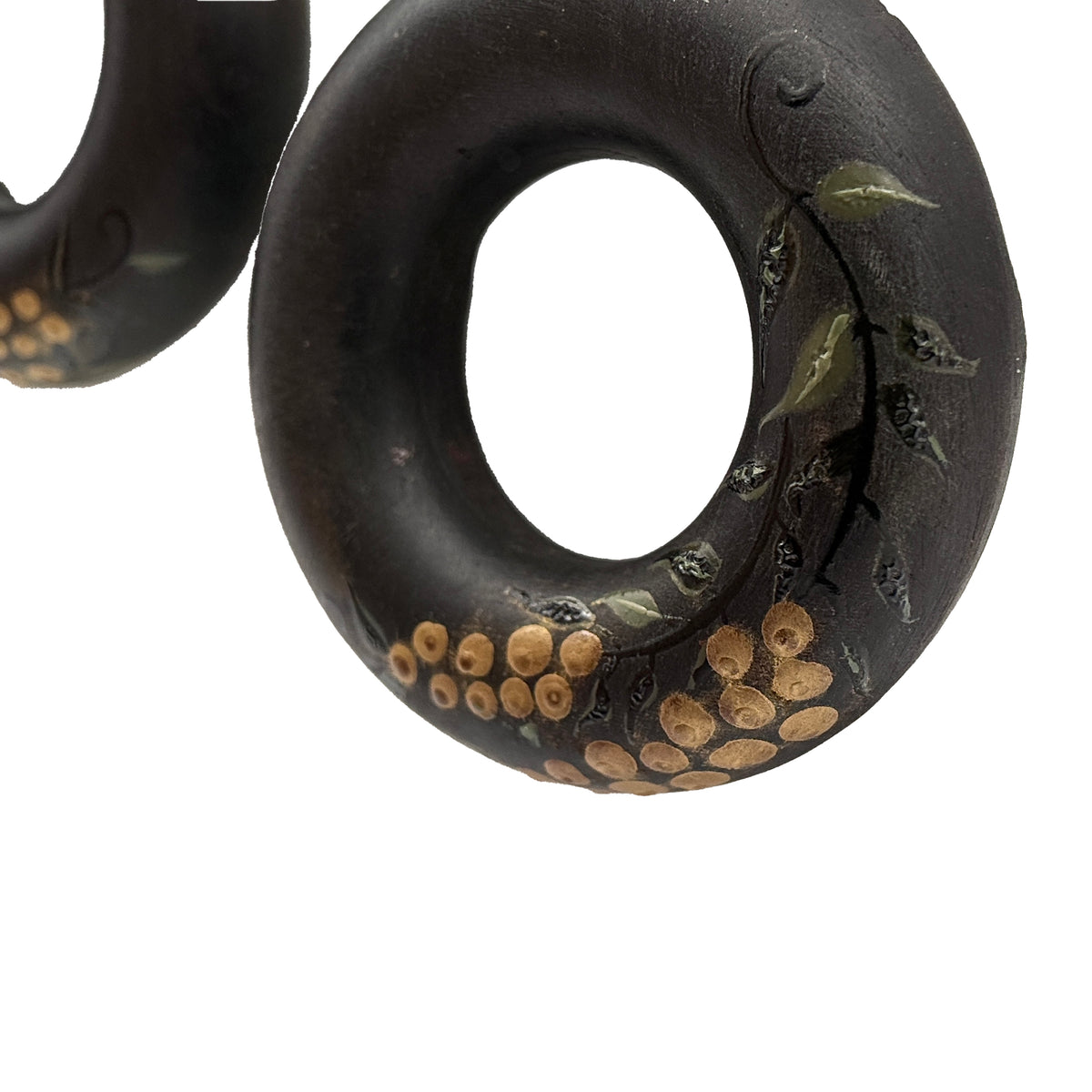Tenjiku Black Lacquer Quasi-Maki-e Earrings — Black rubber donut with nature-themed design on a white background