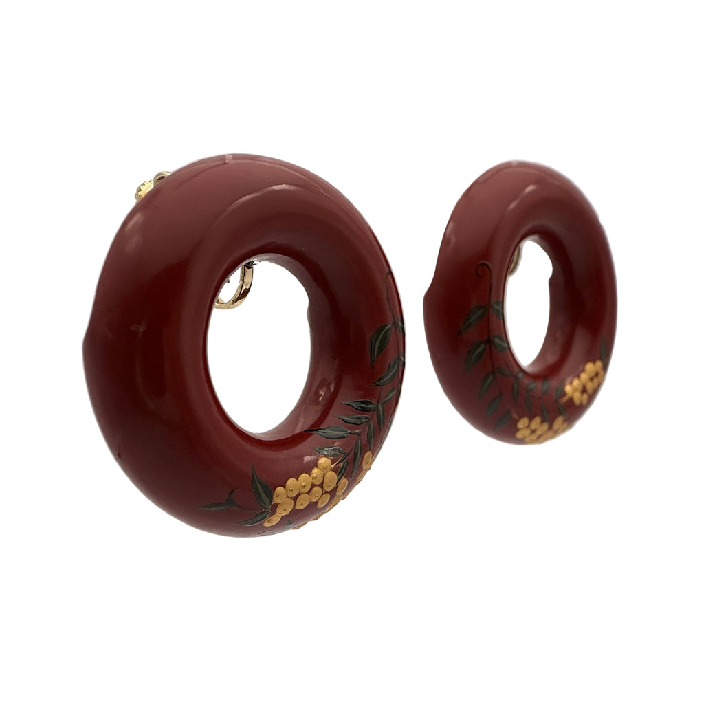 Tenjiku Red Lacquer Quasi-Maki-e Earrings — Pair of red hoop earrings with floral designs on a white background