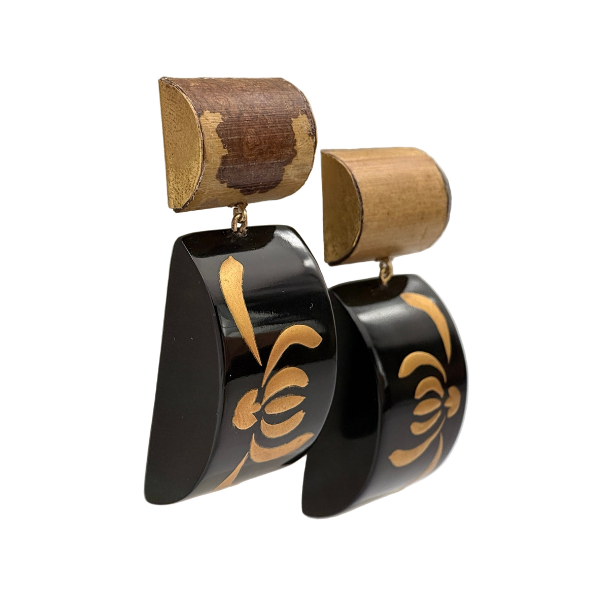 Tranquil Bamboo Lacquer Quasi-Maki-e Earrings — Black earrings with gold patterns on a beige cushion