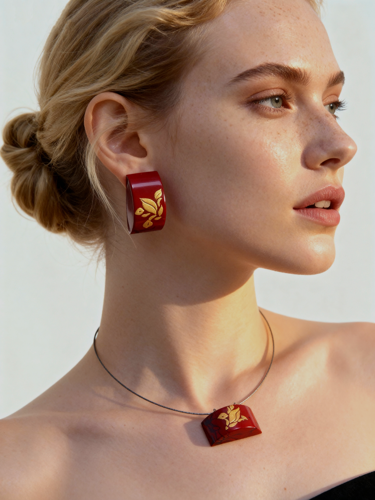 Tranquil Magnolia Lacquer Quasi-Maki-e Earrings — Woman wearing red earrings and necklace with a plain background