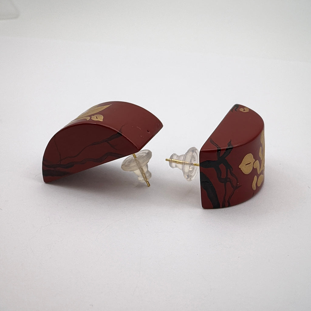 Tranquil Magnolia Lacquer Quasi-Maki-e Earrings — Pair of maroon earrings with gold accents on a white background