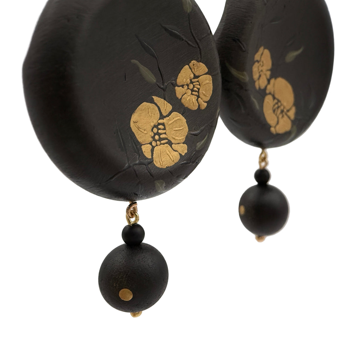 Twin Blossoms Black Lacquer Drop Earrings — Black earrings with gold floral designs on a white background