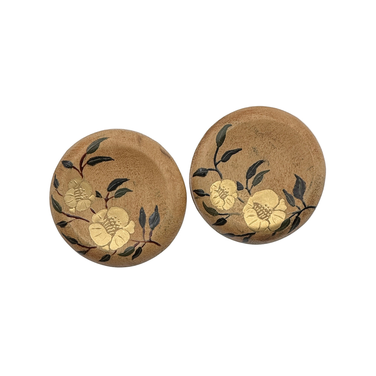 Twin Blossoms Natural Lacquer Earrings — Two round cork coasters with floral designs on a white background