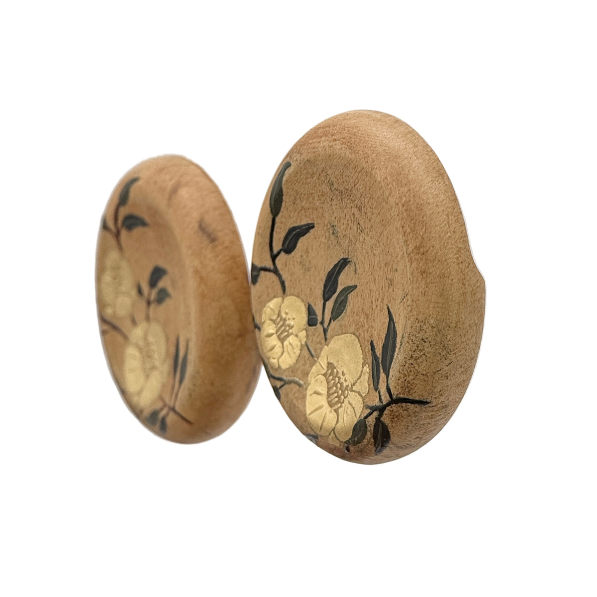 Twin Blossoms Natural Lacquer Earrings — Pair of wooden earrings with floral design on a clear stand.