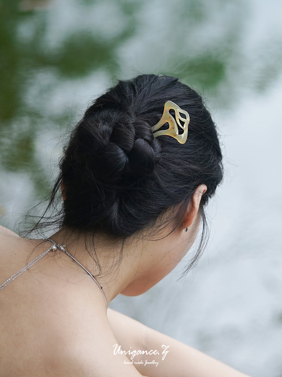Welcoming Pine Hairpin — Woman with braided hair wearing a gold hair clip, blurred natural background